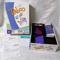 Open box displaying cards, timer, buzzer, holders