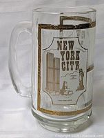 Full view of clear glass mug showing New York City graphic and handle