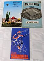 All three football programmes laid out