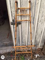 Full view of bamboo easel leaning against wall