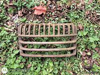 Top view of entire cast iron grate on grass