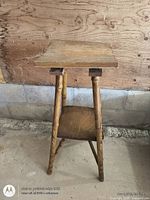 Full view of wooden fern stand showing top, legs, and stretcher, worn finish