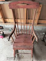Front view of wooden spindle rocking chair showing overall design and wear