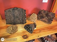 Five carved wood printing blocks on shelf