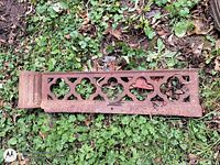 Full view of cast iron tread on grass showing decorative cut-outs