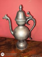 Front view showing dragon spout, lid, handle, pedestal