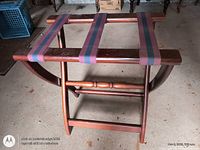 Wooden folding luggage rack fully opened showing fabric straps