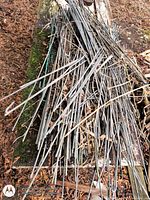 Pile of galvanized steel rods on wooden surface