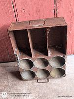 Full view of metal tray showing three top slots, six round holders, front handle