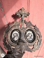 Front view of carved wood frame showing crucifix and two oval prints