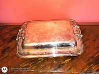 Covered silver-plated platter showing overall form