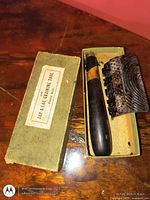 Tool in open box showing label, handle and comb head