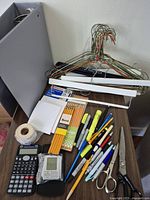 overall lot with binder, hangers, pencils, calculator, pens, scissors