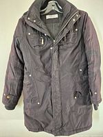 Front view of dark brown winter jacket on hanger