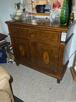 Front view of buffet showing drawers, doors and inlay