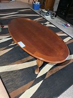 top view of oval wood coffee table on rug
