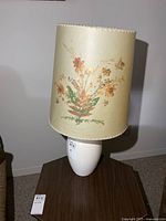Full view of lamp showing floral shade and ceramic base