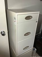Front view of white metal 3-drawer file cabinet