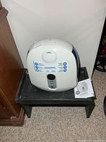 Front and top view of humidifier on stand with manual