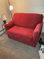 Front view of red La-Z-Boy loveseat sleeper