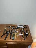 All watches and straps spread on dresser