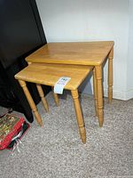 Pair of light wooden nesting tables together