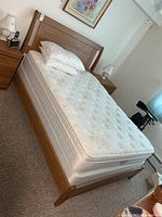Full view of assembled queen bed with mattress and box spring