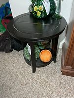 Full view of round side table with lower shelf