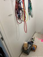 Bungee cords hanging, toolbox and items on floor