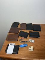Full lot with nine wallets, three pocket knives and matchbook