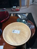 Top view of wooden bowl, ceramic loon, glass ashtray