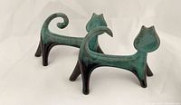 two green glazed modernist cat figurines side view