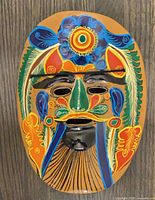 Front view of multicolor hand-painted Mexican clay mask