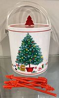 Front view of ice bucket with tree graphic and six stir sticks