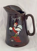 Full view of pitcher front showing rooster graphic and "Syrup" text