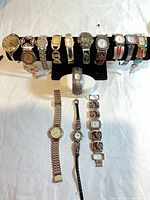 Overview of all 14 watches on display stand and table