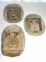 Front view of three cement face plaques