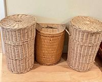 Front view of all three wicker hampers with lids