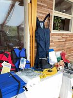 overview of lot showing oars, coveralls, boots and various boating items