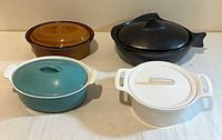 Group view of four casserole dishes with lids