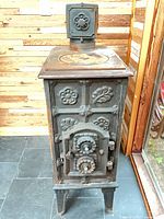 Front view showing floral relief panels, door, legs