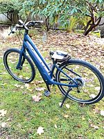 Left side view of blue Specialized Como e-bike on grass