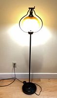 Full view of floor lamp showing shade illuminated
