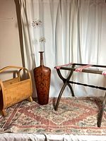 Group shot showing magazine rack, tall vase, rug and luggage rack