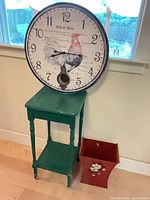 Clock, side table and waste basket grouped together for scale
