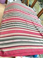 Entire mattress displayed on surface showing full striped serape cover