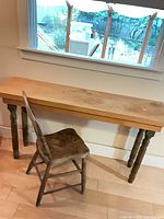 table and chair together by window