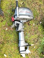 Full view of Tohatsu outboard motor with propeller and tiller handle
