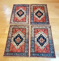 Four matching rugs laid out together