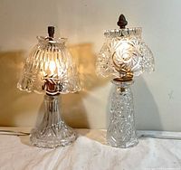 Both glass lamps illuminated side by side